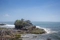 Structure of rock construction standing on the seashore in beautiful sunny day with the view of horizon in Tanah lot, Bali