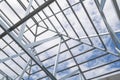 Structure of steel roof frame with blue sky at constr