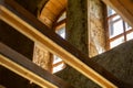 Structures and windows of a wooden ecohouse with clay plaster. Bottom view