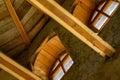 Structures and windows of a wooden ecohouse with clay plaster. Bottom view