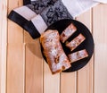 Strudel with apples, strudel on a black and wooden plate on a wooden table Royalty Free Stock Photo