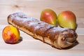 Strudel with apples, yellow red peaches, pears on a wooden board, closeup Royalty Free Stock Photo