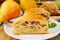 Strudel with pears and mint in bowl on board