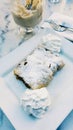 Strudel with powdered sugar and cream at cafe. Royalty Free Stock Photo