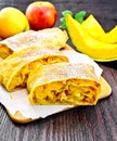 Strudel pumpkin and apple with raisins on wooden board Royalty Free Stock Photo