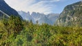 Strudelkopf - Panoramic view on the high Italian Dolomites peaks. There are dense pine trees in the front, distant mountain peaks Royalty Free Stock Photo