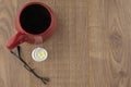 The struggle against Drowsiness : caffeine pills near the box for tablets, glasses, and a red mug of strong coffee on the wooden