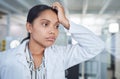 The struggle is real but so are the rewards. a young scientist looking stressed while conducting research in a