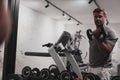 Struggling with age. Confident senior man exercising with dumbbells in health club. Selective focus Royalty Free Stock Photo