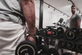 Struggling with age. Confident senior man exercising with dumbbells in health club. Selective focus Royalty Free Stock Photo