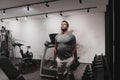 Struggling with age. Confident senior man exercising with dumbbells in health club. Selective focus Royalty Free Stock Photo