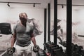 Struggling with age. Confident senior man exercising with dumbbells in health club. Selective focus Royalty Free Stock Photo