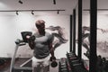 Struggling with age. Confident senior man exercising with dumbbells in health club. Selective focus Royalty Free Stock Photo