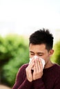 Struggling with the symptoms of flu. a young man blowing his nose. Royalty Free Stock Photo