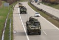 Strykers,wheeled armored vehicles drive on highway . Royalty Free Stock Photo