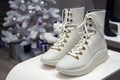 MINSK, BELARUS - December 13, 2019: Stuart Weizman women`s high white boots on a shelf in a company boutique Stuart Weizman