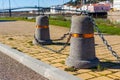 Stub posts linked in a chain on a quay