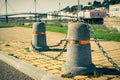 Stub posts linked in a chain on a quay