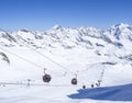 Stubai Glacier, AUSTRIA, May 2, 2019: Snow covered slopes with free rides and pistes and red Cable cars and chair lifts