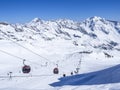 Stubai Glacier, AUSTRIA, May 2, 2019: Snow covered slopes with free rides and pistes and red Cable cars and chair lifts