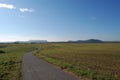 Stubble field with street Royalty Free Stock Photo