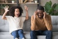 Stubborn african child girl in tantrum screaming at black father Royalty Free Stock Photo