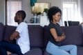 Stubborn black couple sitting on couch ignoring each other Royalty Free Stock Photo