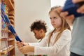 stubborn girl pulling beads near interracial Royalty Free Stock Photo