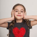 Stubborn little girl blocking her ears with hands Royalty Free Stock Photo