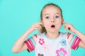 Stubborn little kid with an attitude ignoring parents, blocking her ears with hands. Royalty Free Stock Photo