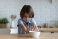 Stubborn little kid boy rejecting eating dry breakfast.