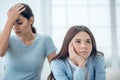 Stubborn teen daughter and upset mom behind Royalty Free Stock Photo