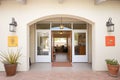 stucco entryway with arched double doors