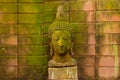 Stucco Face Buddha Goddess Sacred With green moss Royalty Free Stock Photo