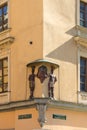 A stucco figure on the corner of the facade of the house