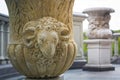 stucco in the form of a ram`s head on an old floral bowl of clay