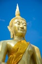 Stucco golden Buddha On a blue sky background