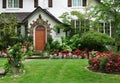 Stucco house with flowers in front yard Royalty Free Stock Photo