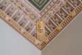 Stucco and luxurious decorative elements on ceiling. Luxury aesthetic in a home decor. Golden lion head pieces on a ceiling Royalty Free Stock Photo