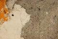 Stucco texture of an old house concrete shabby wall with white, gray, yellow spots and cracks on the rough sandy cement surface. Royalty Free Stock Photo