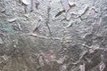 Stucco texture`s background. Fragment of an old wall with silver paint. Peeling of silver paint Royalty Free Stock Photo