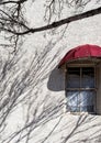 Stucco wall and window, with tree shadows Royalty Free Stock Photo