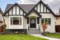 stucco and wood tudor home with a detailed front gable