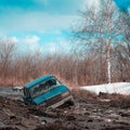 Stuck in dirt and abandoned car on a sunny spring day Royalty Free Stock Photo