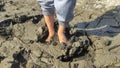 Stuck in the mud. Close-up view of feet walking through muddy path Royalty Free Stock Photo