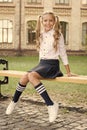 Student adorable child in formal uniform relaxing outdoors. Perfect schoolgirl relaxing between classes. Life balance Royalty Free Stock Photo