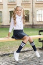 Student adorable child in formal uniform relaxing outdoors. Perfect schoolgirl relaxing between classes. Life balance Royalty Free Stock Photo