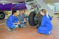 student aeronautical engineers during lesson with professor in hangar