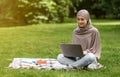 Student arab girl studying at park, using laptop Royalty Free Stock Photo