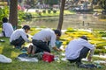 Student of arts painting in the Saranrom Park the Victoria lillies - a genus of water-plants, giant water lilly. Thailand, Bangkok Royalty Free Stock Photo